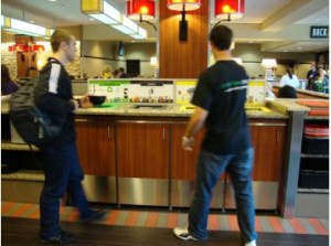 Students separating waste at a BU Dining Hall. Image from RecyclingWorks in Massachusetts. 